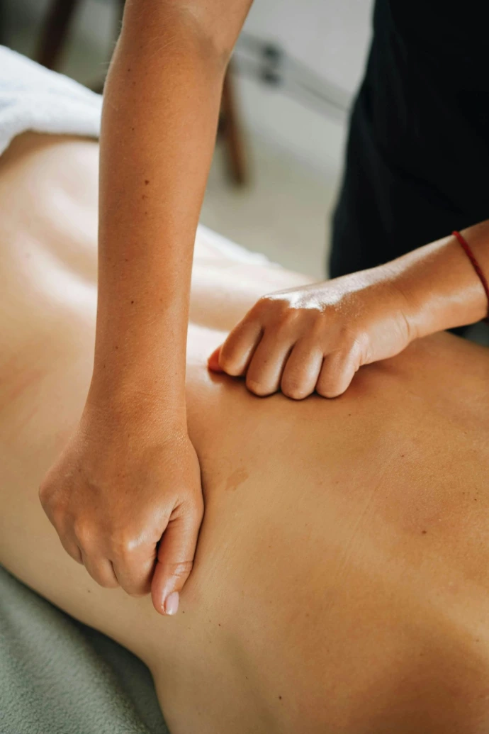 A massage therapist provides a back massage